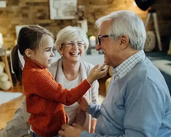 elderly man smiling with grandchildren copy